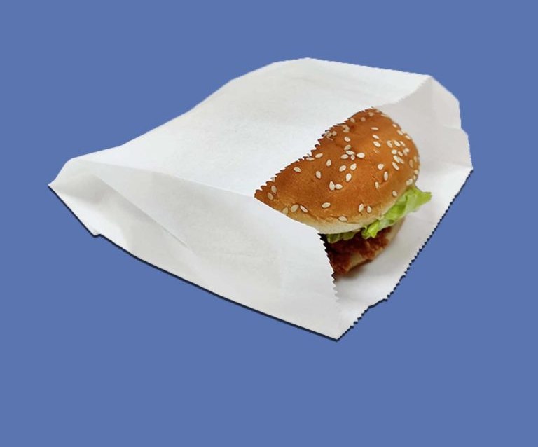 Printed burger sleeve wrapped around a stacked cheeseburger on a counter